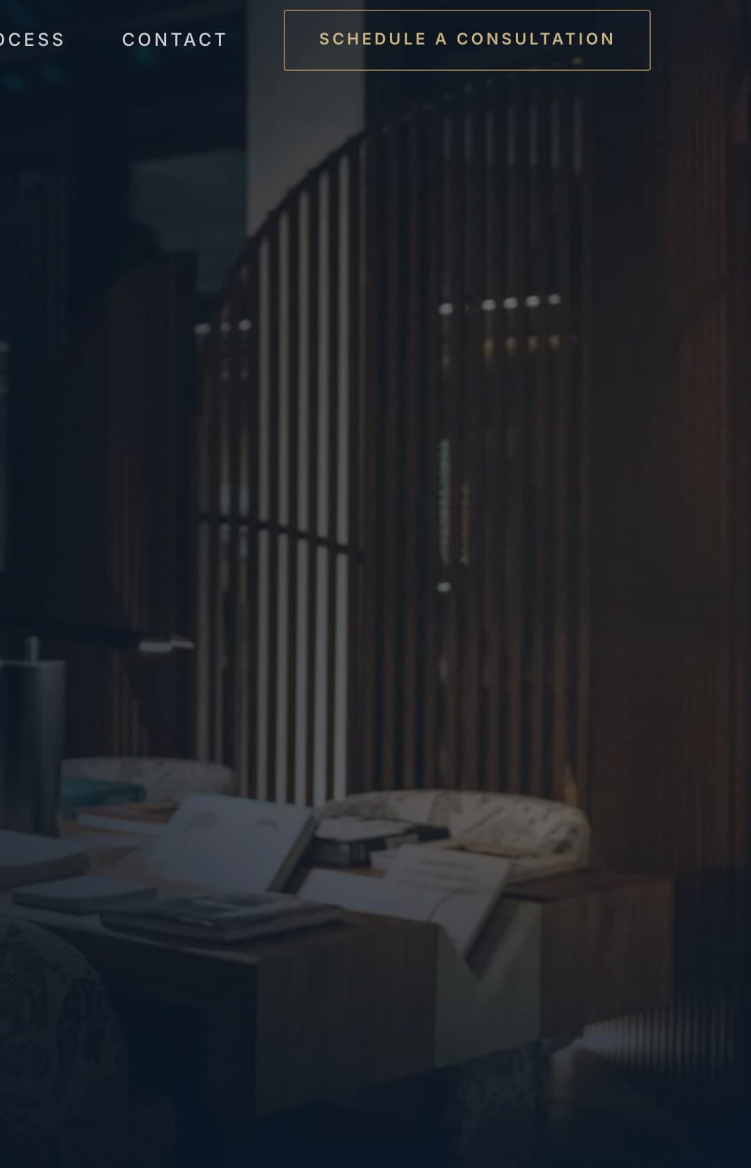 A dark, warmly lit office interior with slatted timber screens and a low table of papers, used as environmental photography across the Hudson Associates Wealth website.